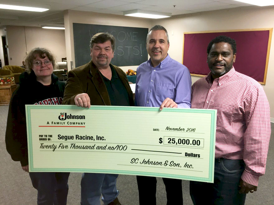 Segue Racine volunteers receive a donation from SC Johnson
