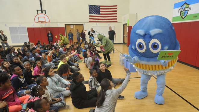 scruby the scrubbing bubbles mascot welcomes students at reading event