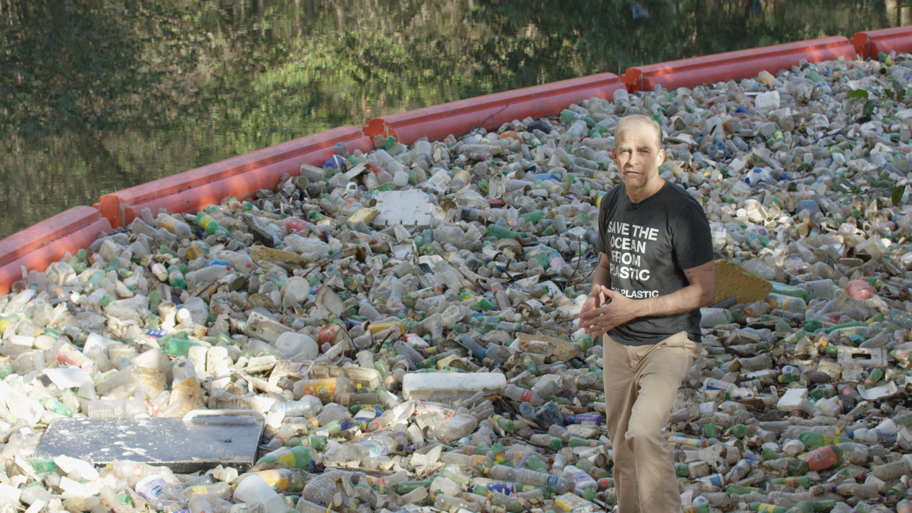 Fisk Johnson at a plastic collection machine in a river