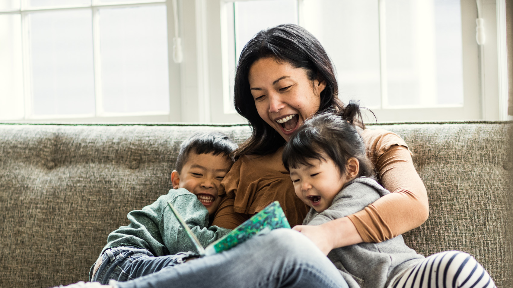 mother reading to her two kids