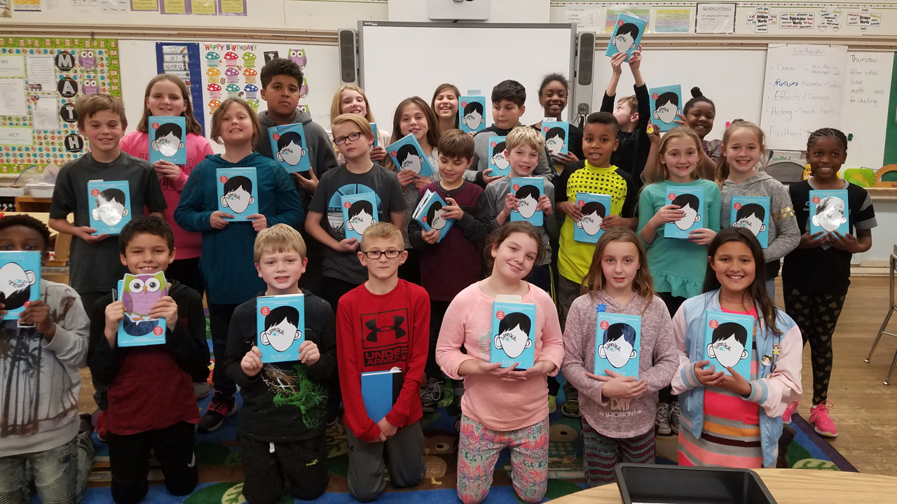 students holding copies of the book Wonder