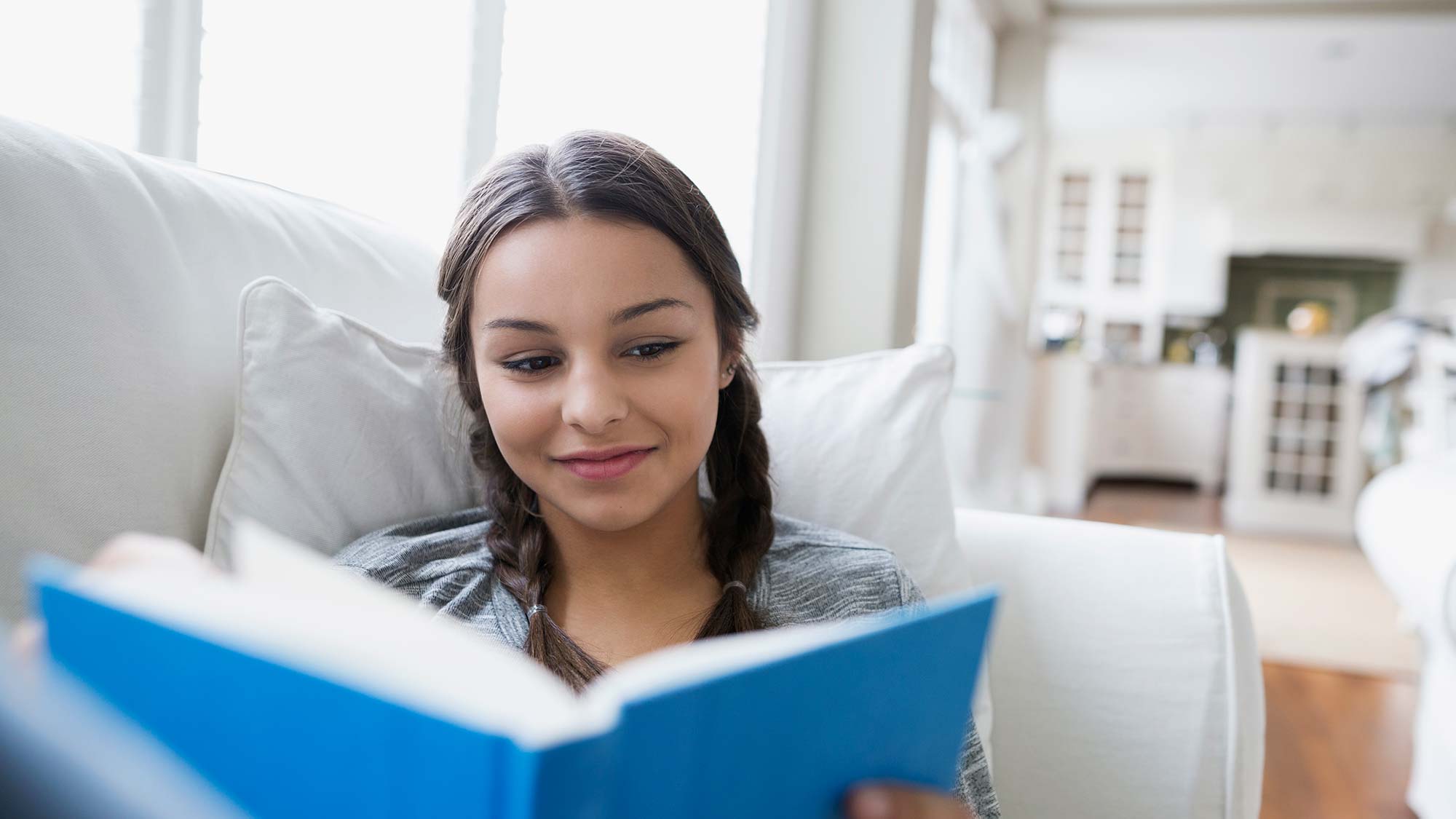 a happy girl reading a book