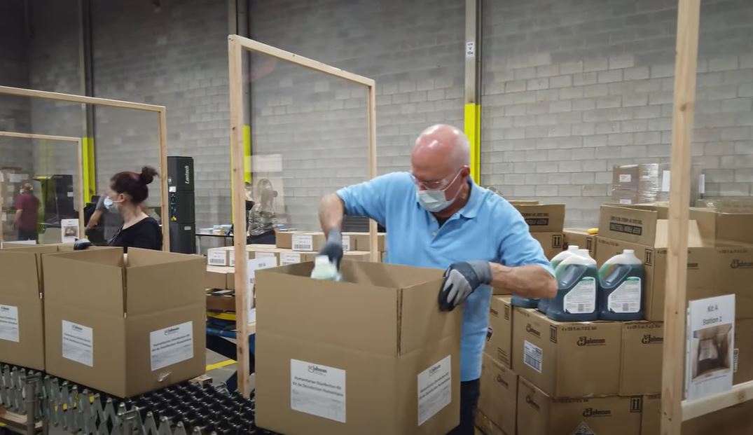 SC Johnson Employee Packing Up Disinfectant Kits to send to Nigeria.