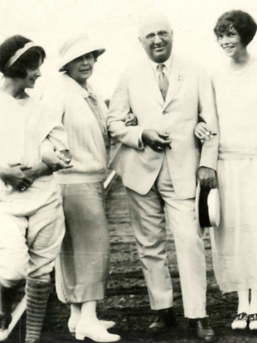 Herbert F. Johnson, Sr. standing in his white suit