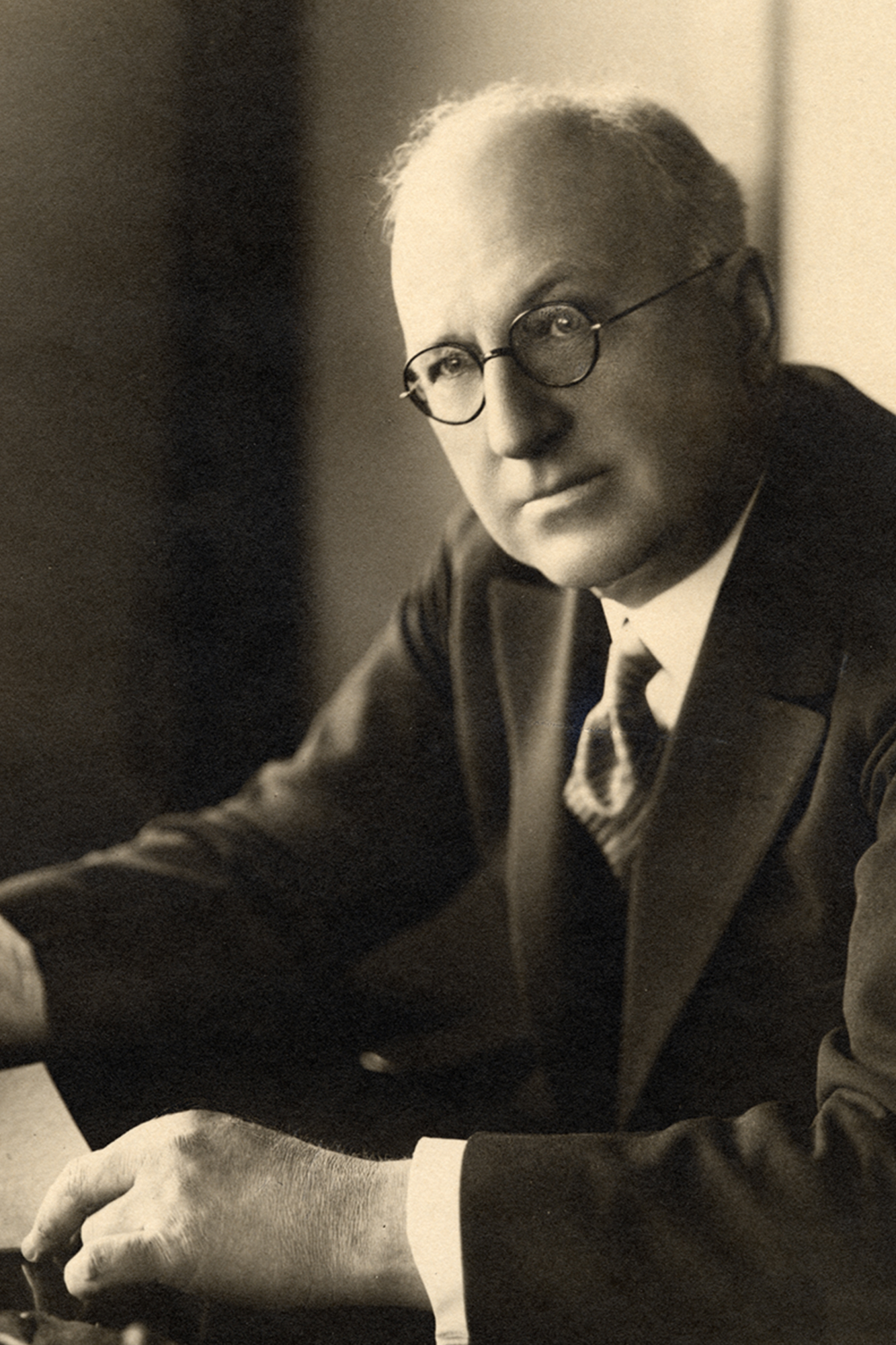 Portrait of Herbert F. Johnson, Sr. sitting at his desk