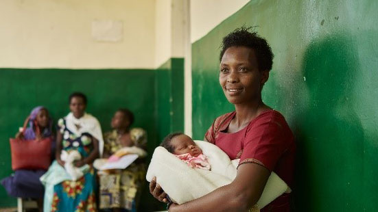 Mother and child outside one of the SC Johnson sponsored Health Clinic in Rwanda.